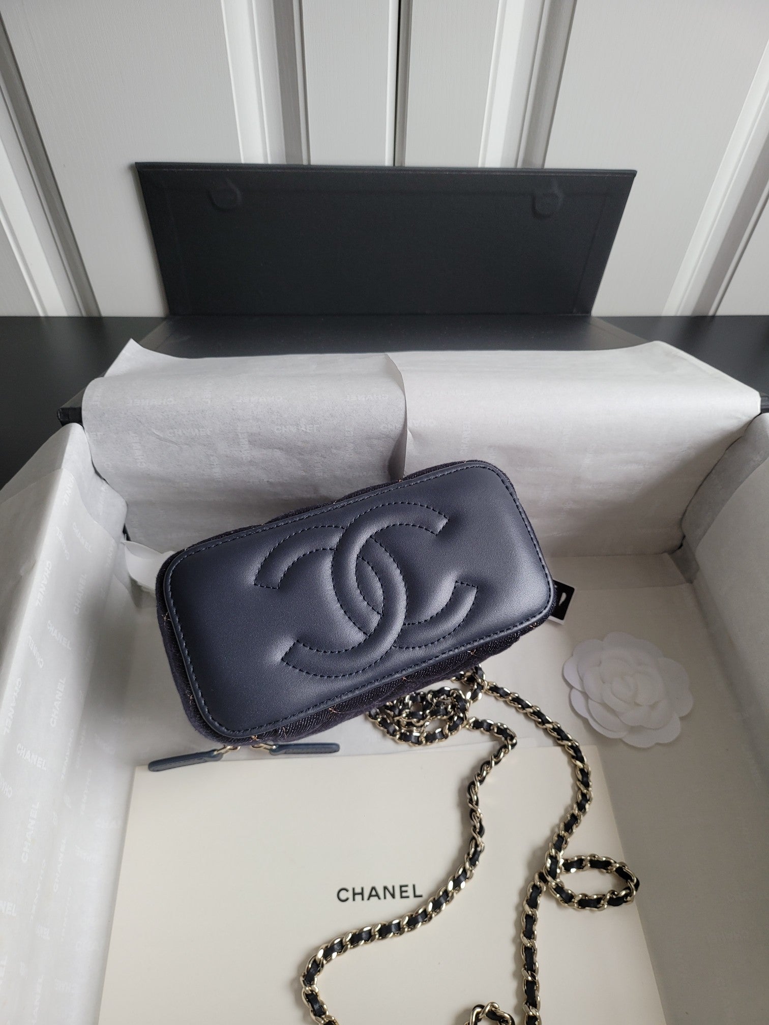 Chanel small shoulder bag with chain strap, dark navy logo and front flap closure