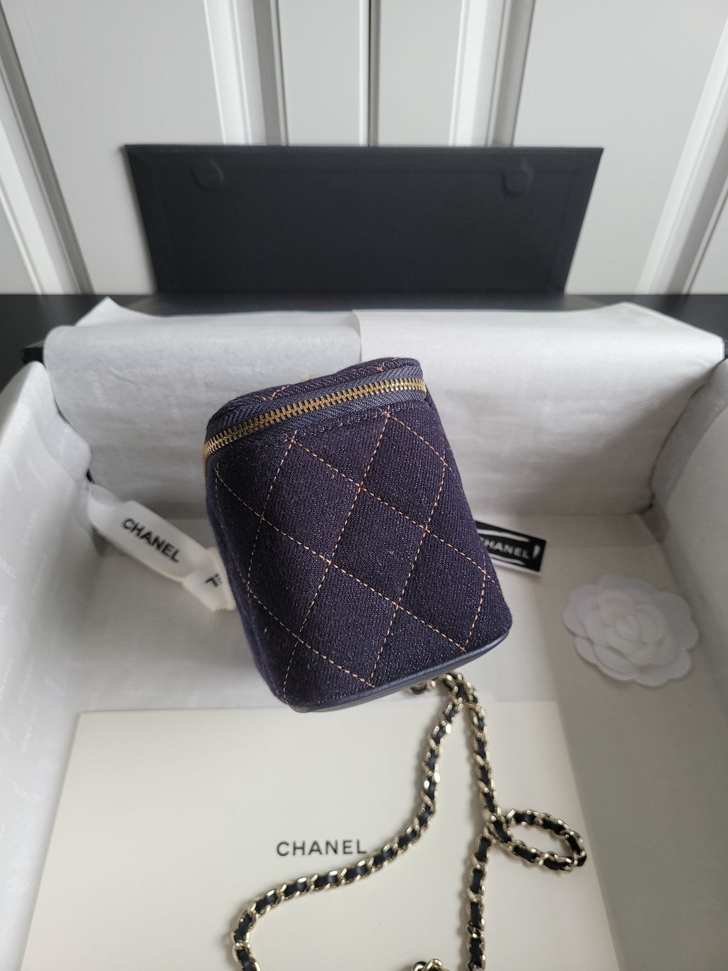 Chanel quilted mini bag with chain strap, dark navy and gold zipper at top