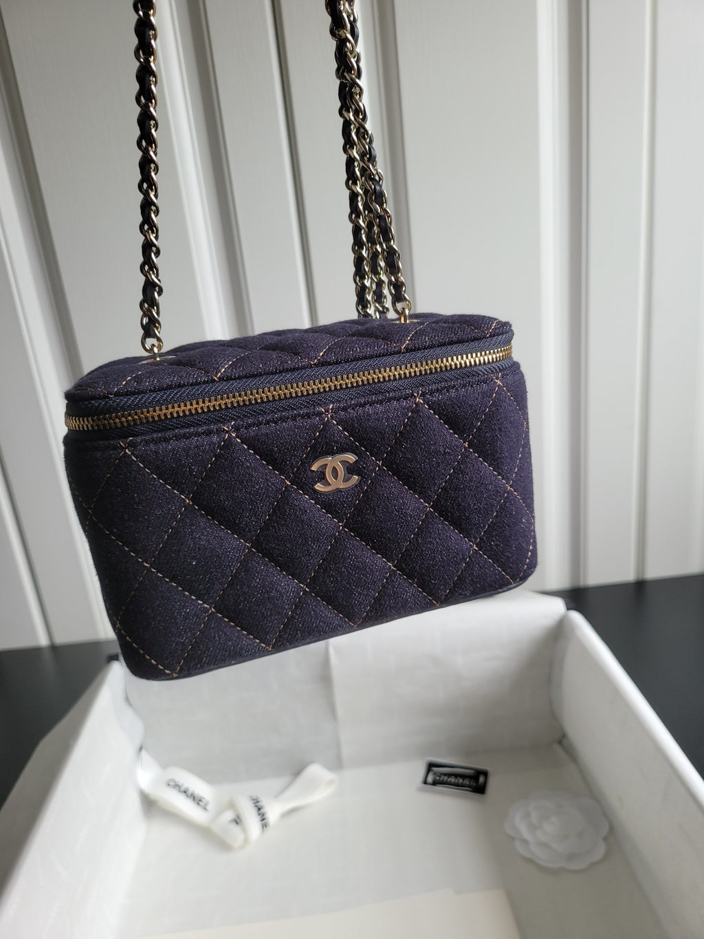 Chanel quilted navy crossbody bag with gold chain strap and zip top