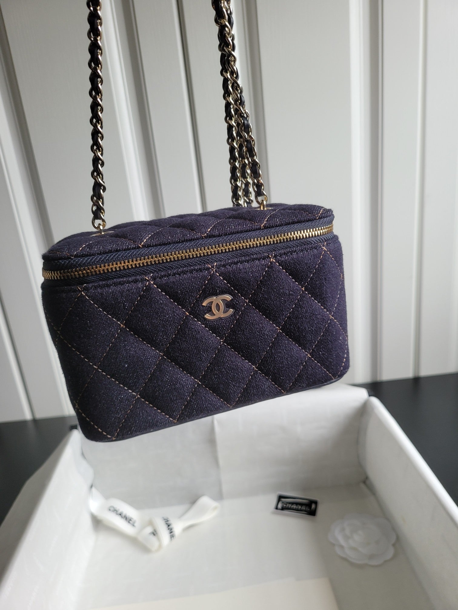 Chanel quilted navy crossbody bag with gold chain strap and zip top
