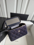 Chanel navy quilted bag open to show card slots and zip compartment