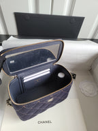 Chanel navy quilted bag open showing interior card slots and zip pouch