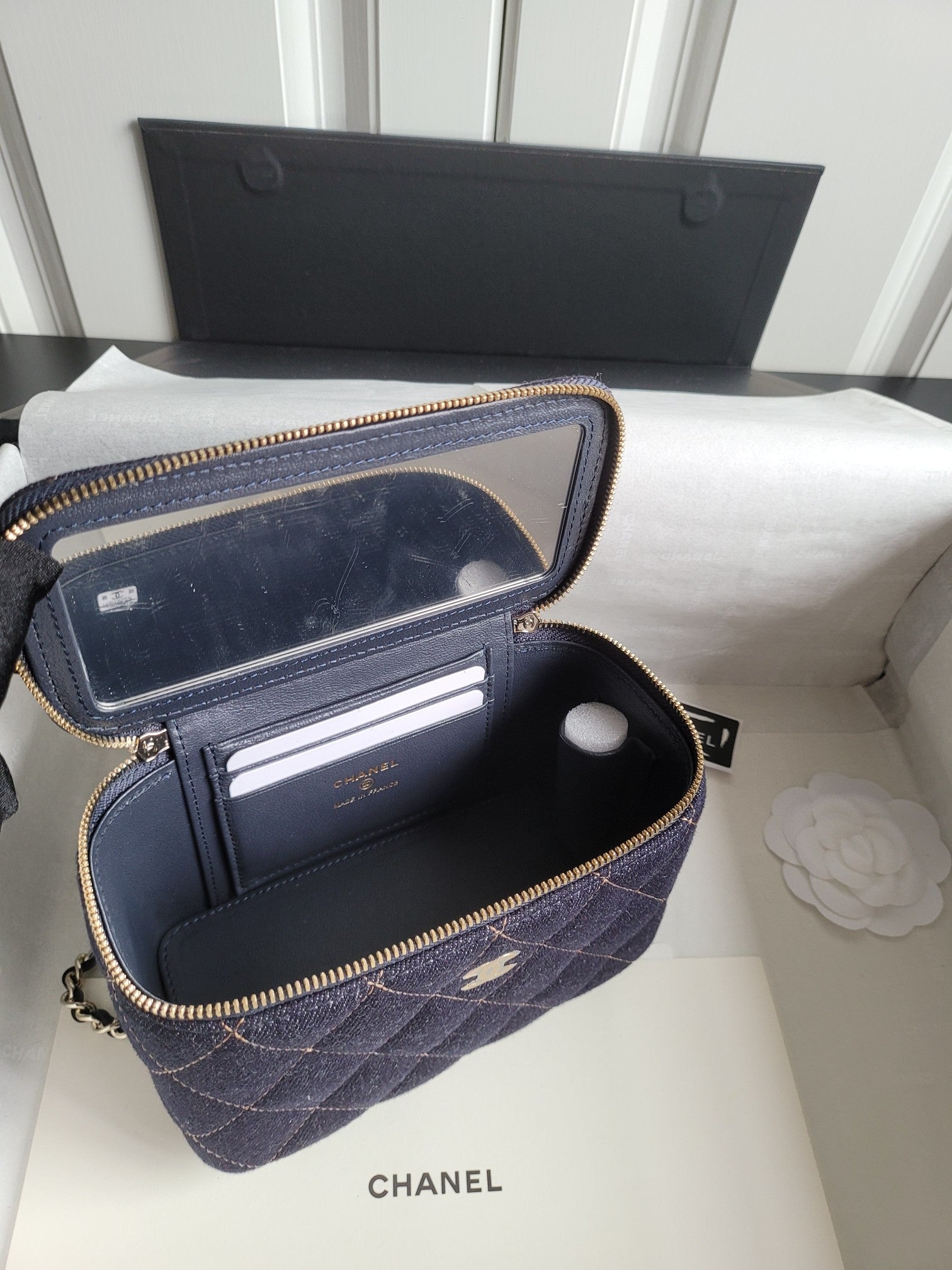 Chanel navy quilted bag open showing interior card slots and zip pouch