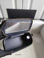 Chanel navy quilted bag interior view with zip pocket and slip compartments