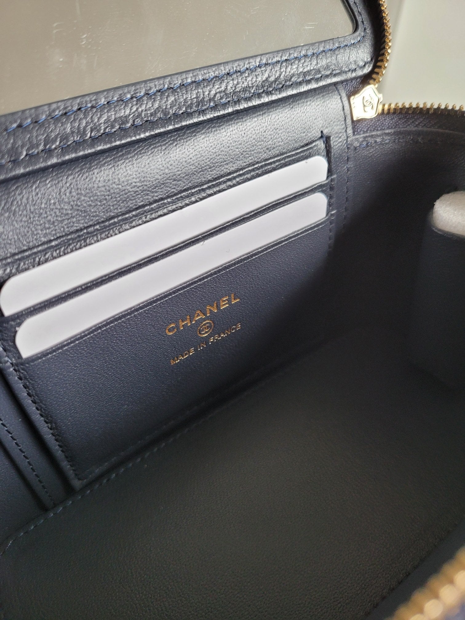 Card holder slot in Chanel quilted bag, with embossed logo