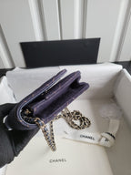 Quilted navy Chanel shoulder bag with chain strap on front flap and clasp
