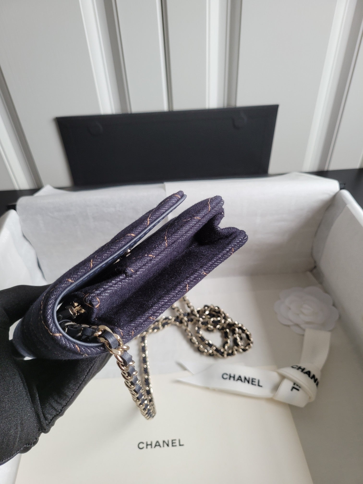 Quilted navy Chanel shoulder bag with chain strap on front flap and clasp