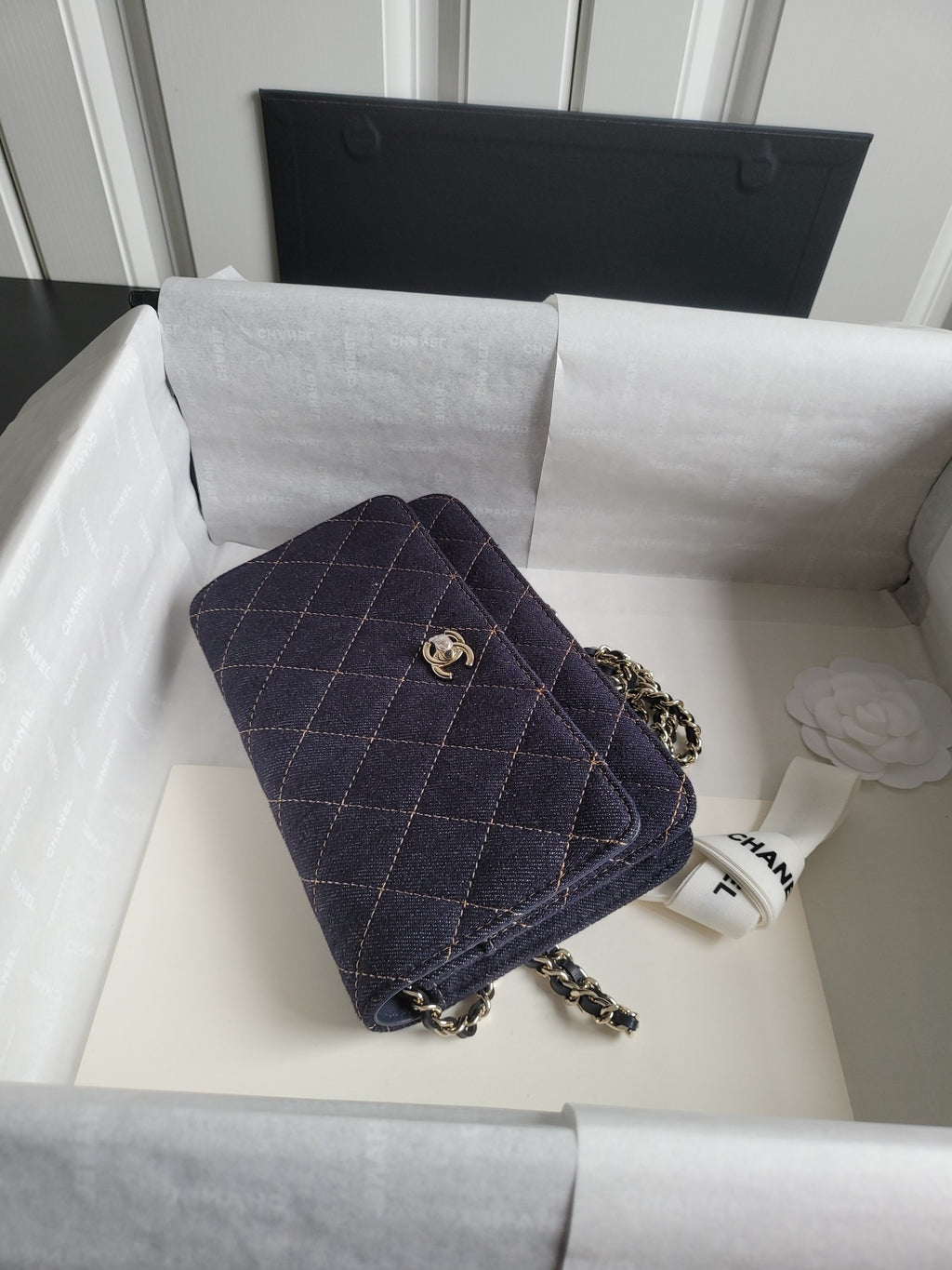 Quilted navy Chanel shoulder bag with chain strap and front flap, gold CC emblem