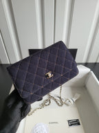 Quilted navy Chanel flap shoulder bag with gold CC clasp and chain strap