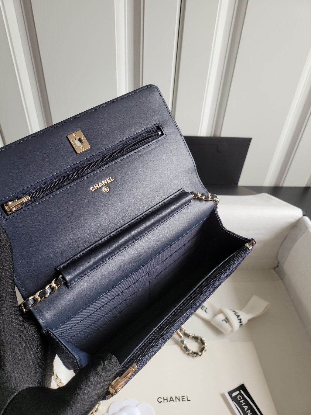 Navy Chanel leather shoulder bag with front flap, chain strap, and gold hardware