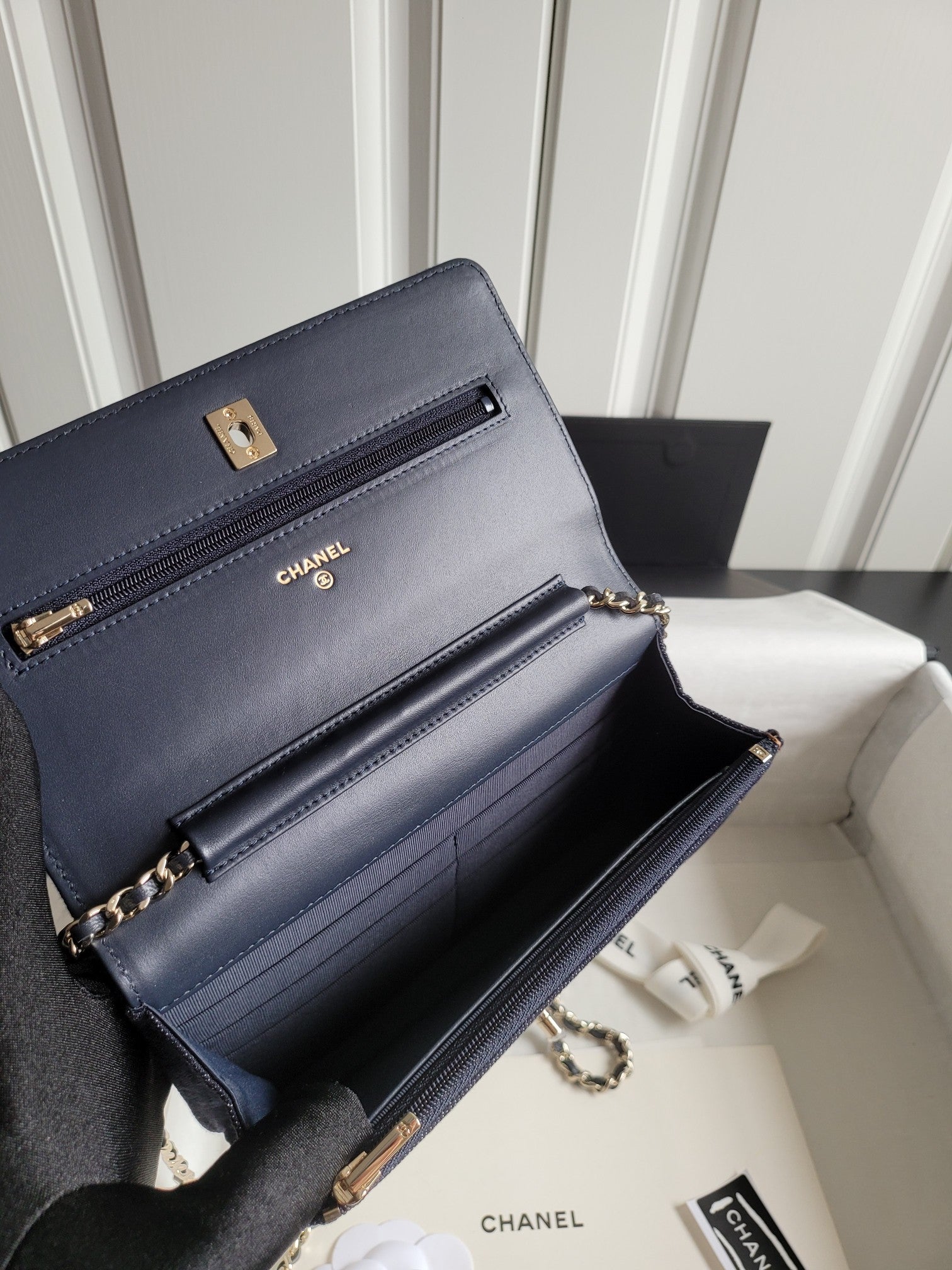 Navy Chanel leather shoulder bag with front flap, chain strap, and gold hardware