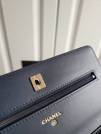 Navy Chanel leather shoulder bag front detail with gold buckle and zipper pocket