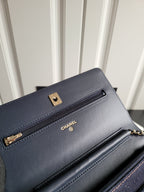 Navy Chanel flap bag with gold hardware, front zipper and stitched trim