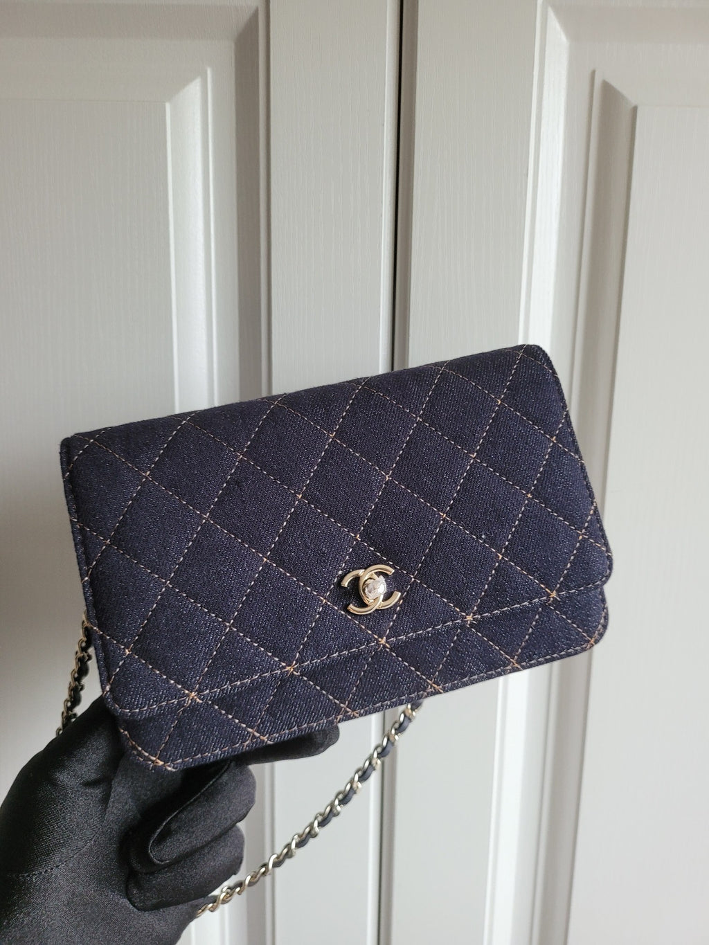 Navy quilted Chanel shoulder bag with gold-tone logo clasp and chain strap
