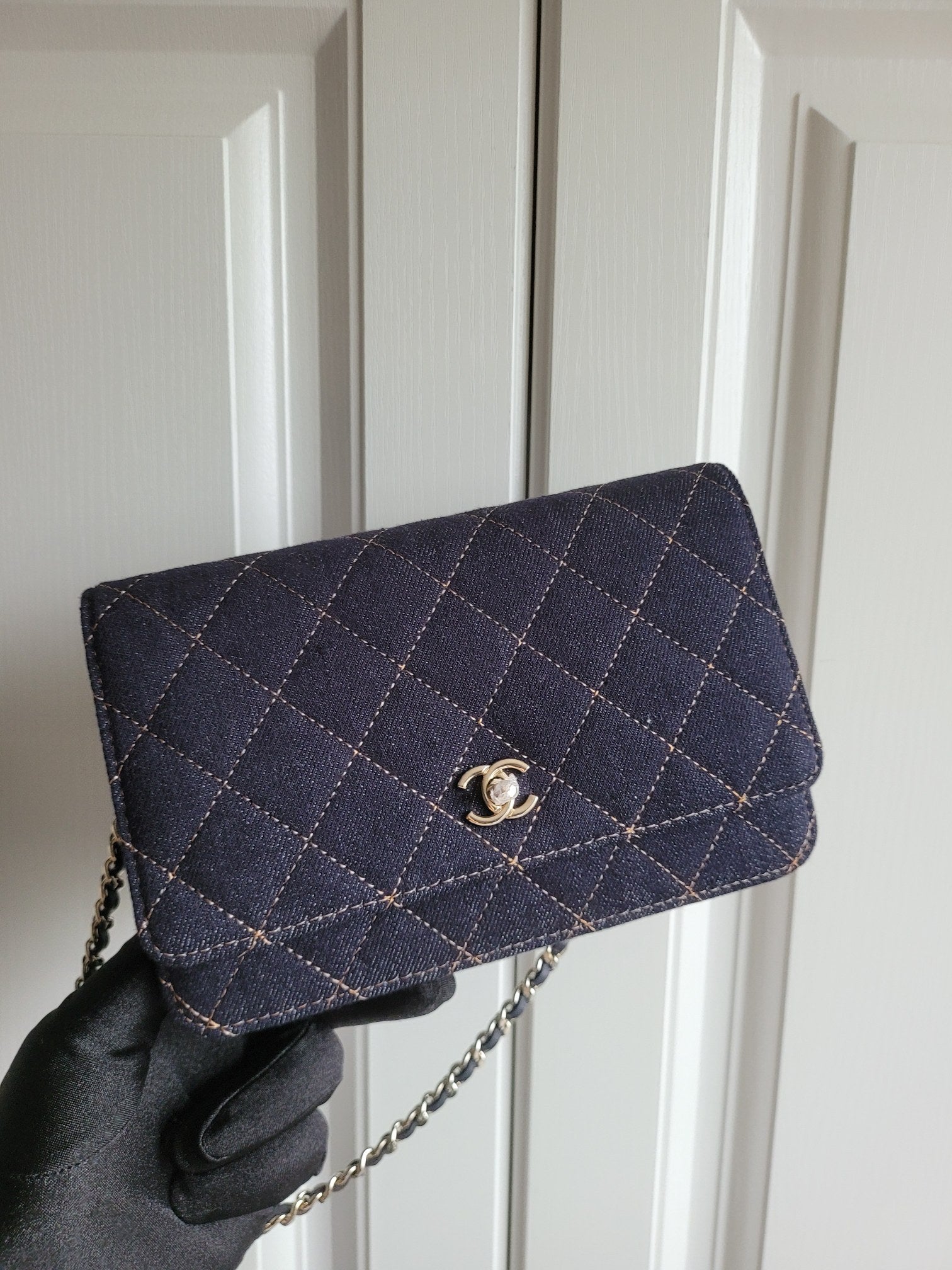 Navy quilted Chanel shoulder bag with gold-tone logo clasp and chain strap