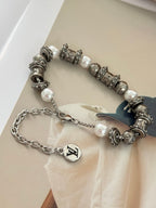 Silver-tone beaded charm bracelet with white pearl beads and dangling chain, LV logo