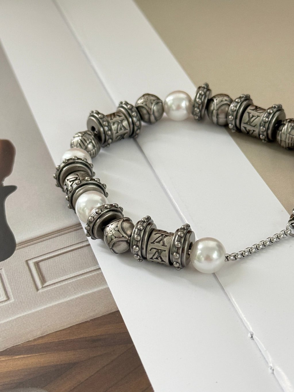 Silver-tone beaded charm bracelet with pearl beads and chain extender, LV logo charm