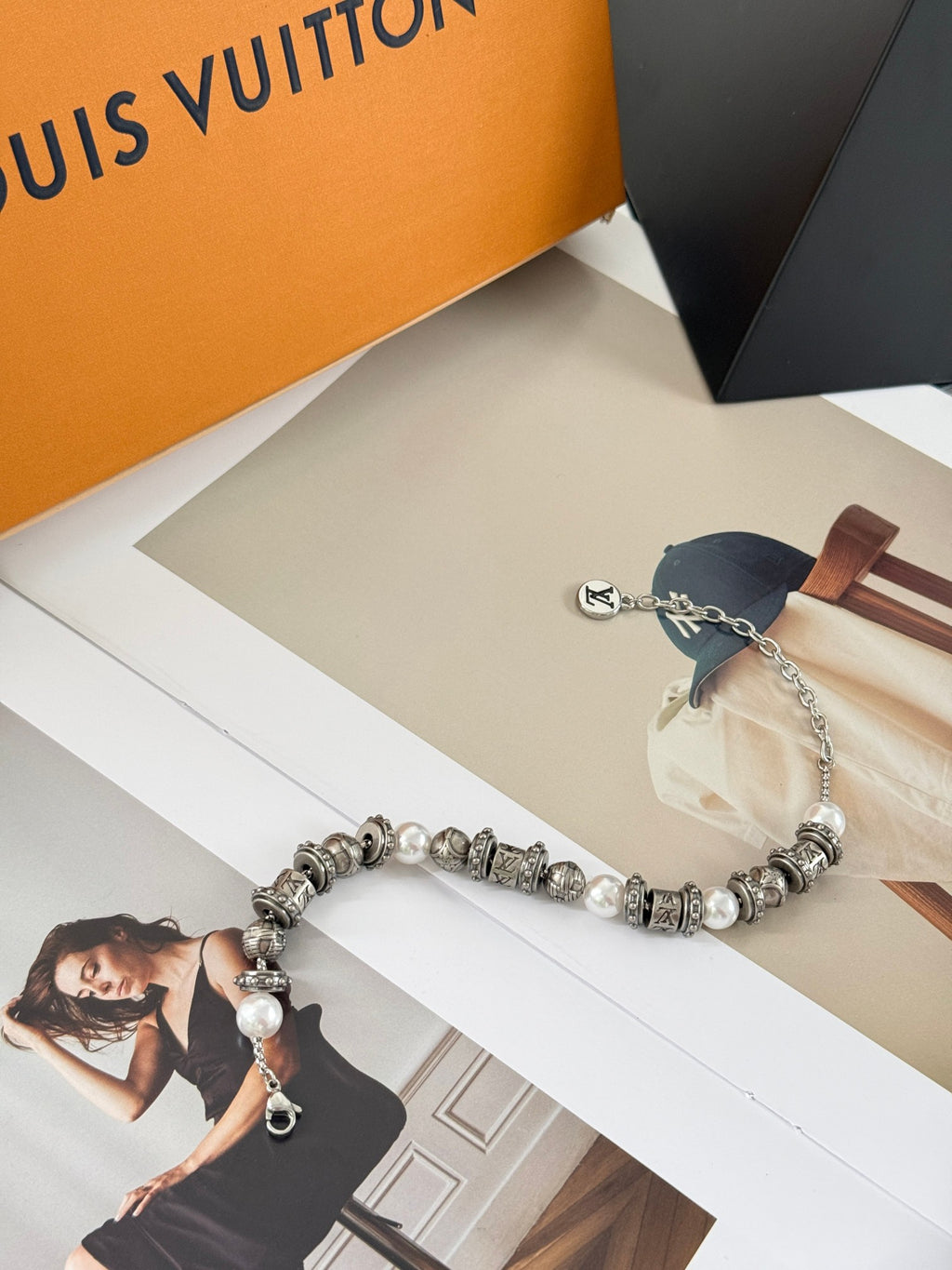 Silver-tone beaded bracelet with pearl accents and chain drop, LV logo charm