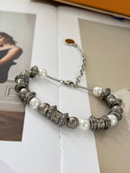 Silver-tone beaded charm bracelet with pearl beads and LV logo charms, chain extender