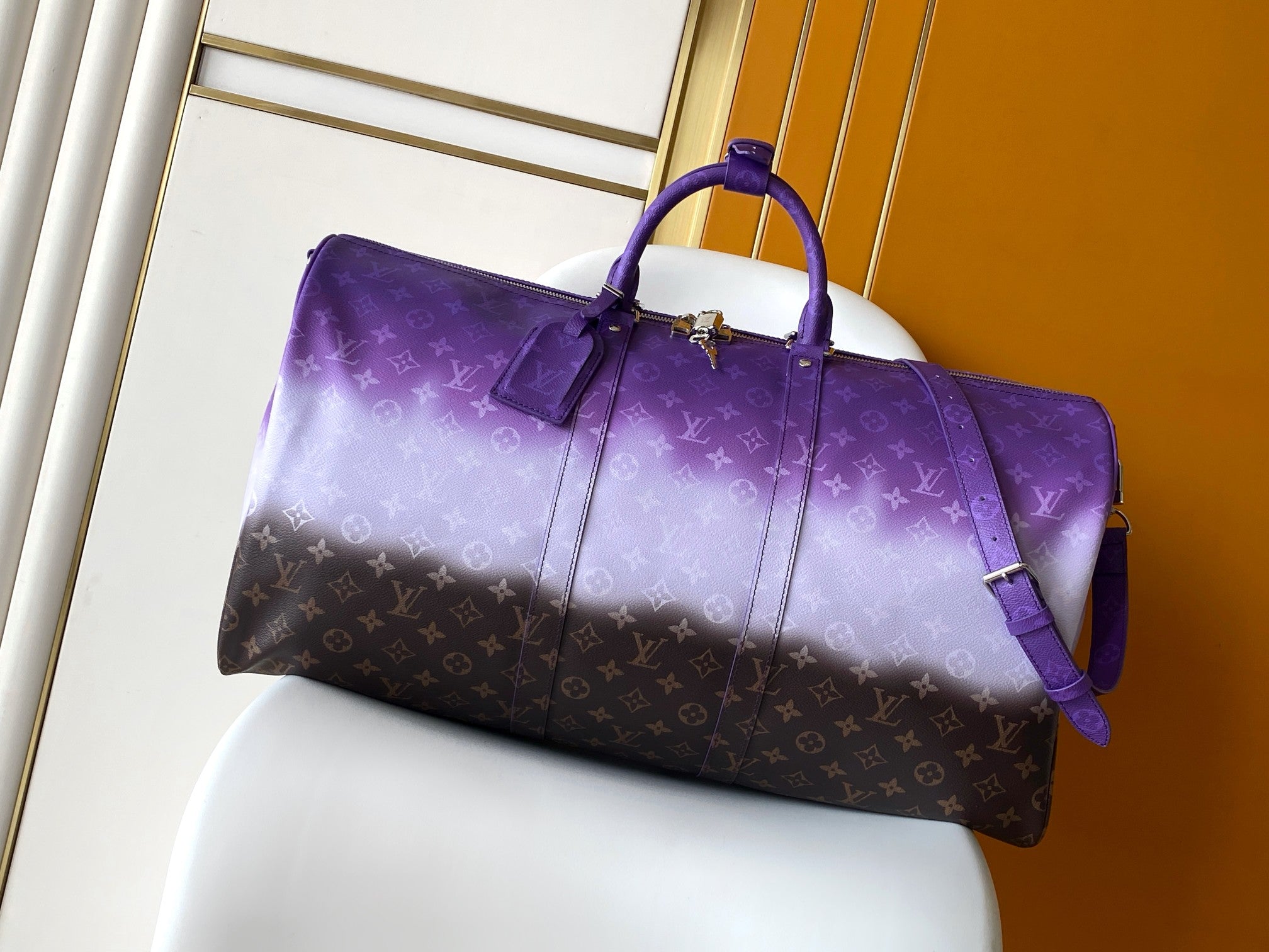 Louis Vuitton duffle bag in purple with monogram pattern and top handles