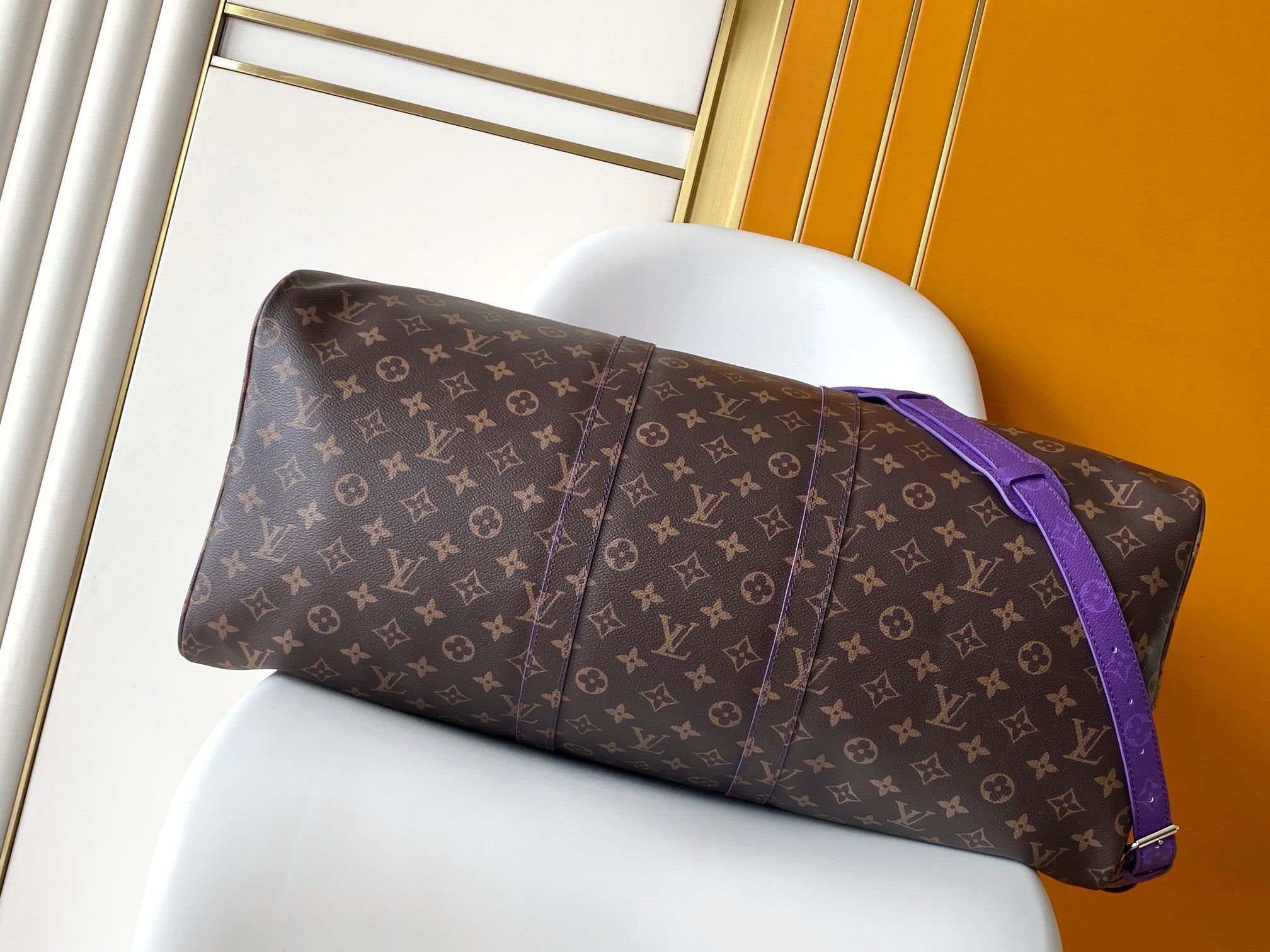 Brown monogram duffle bag with purple side strap and top handles