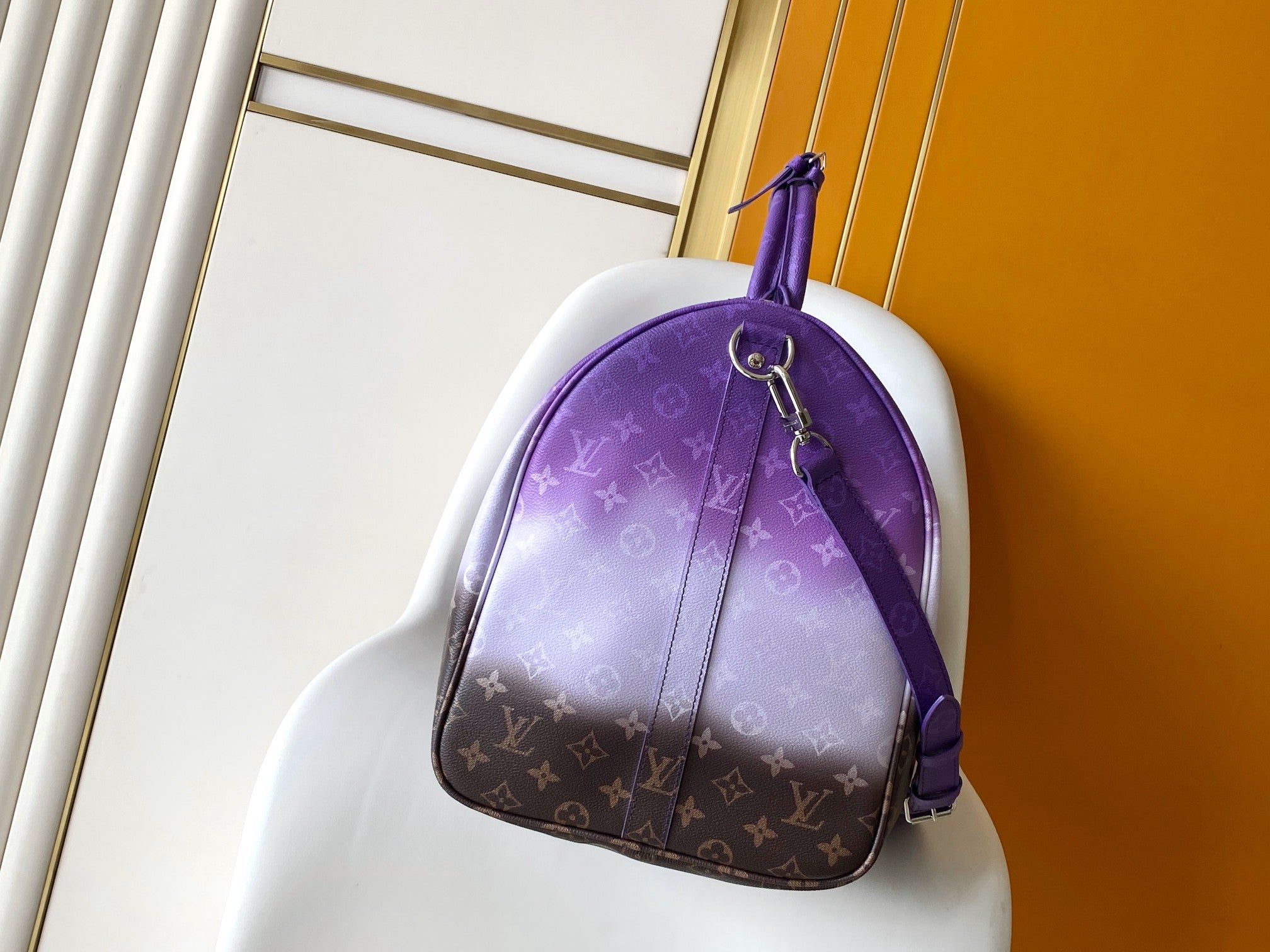 Purple monogram hobo bag with top handle, silver ring hardware, and shoulder strap
