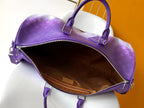 Purple monogram duffle bag interior with brown lining and zippered opening