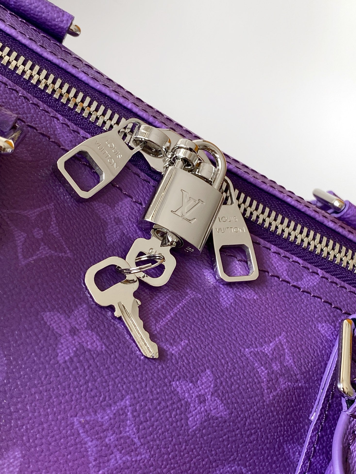 Purple bag zipper with silver lock hardware and metal key charm