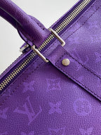 Purple leather strap with silver buckle hardware and stitched reinforced seam