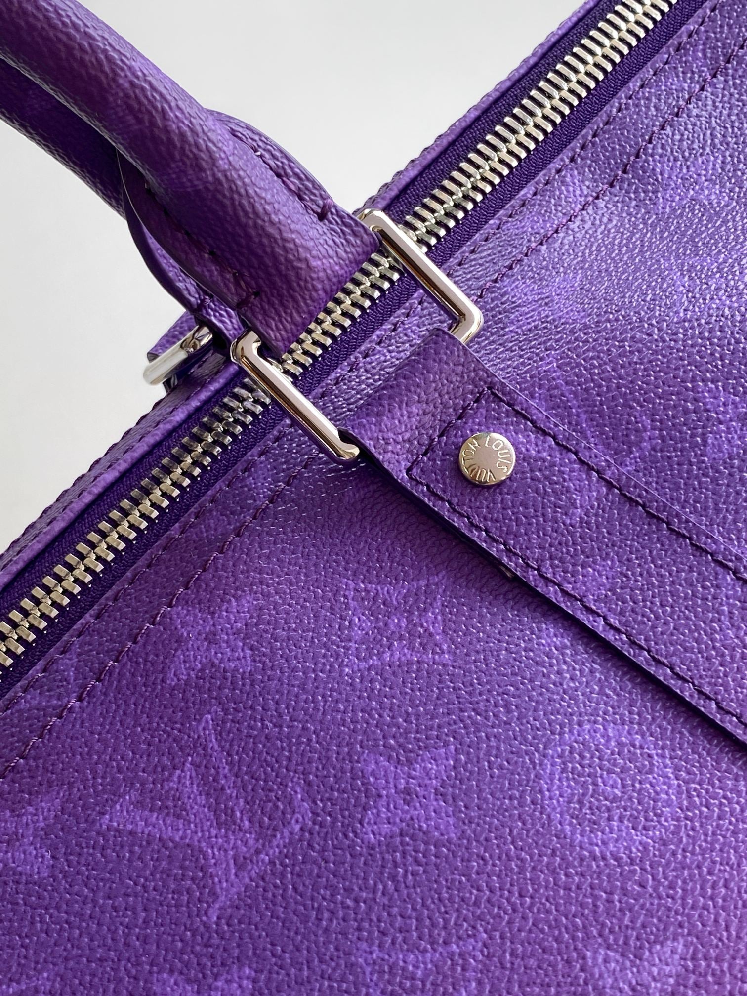 Purple leather strap with silver buckle hardware and stitched reinforced seam