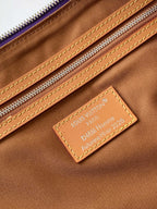 Brown lined duffle bag with leather Louis Vuitton Paris luggage tag and stitching