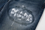 Prada denim pants leg close-up with oval graphic print and decorative lines