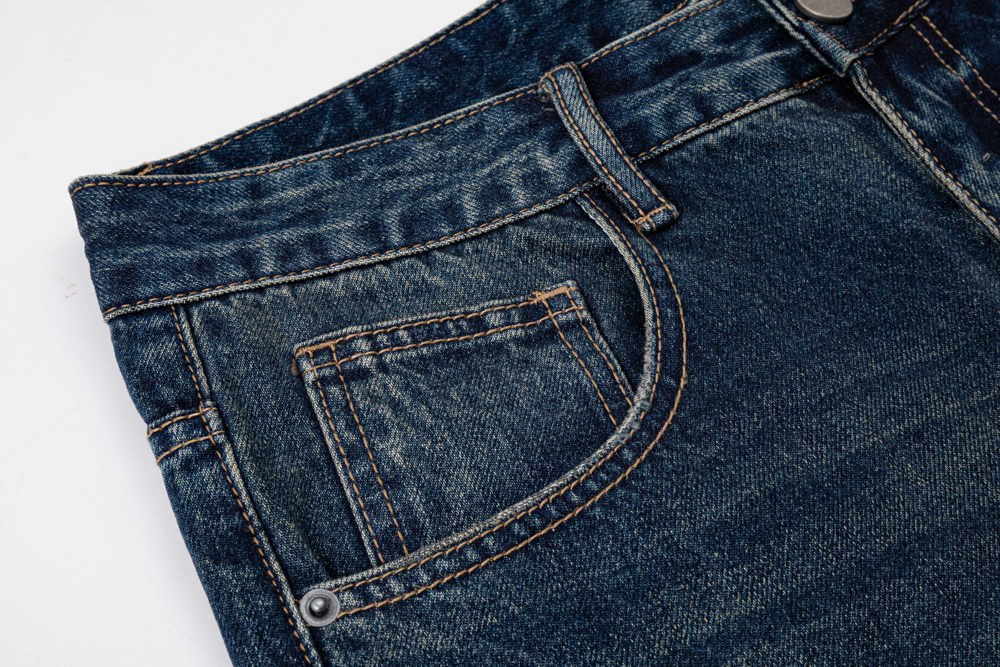 Prada denim pants front pocket close-up with contrast stitching and rivet
