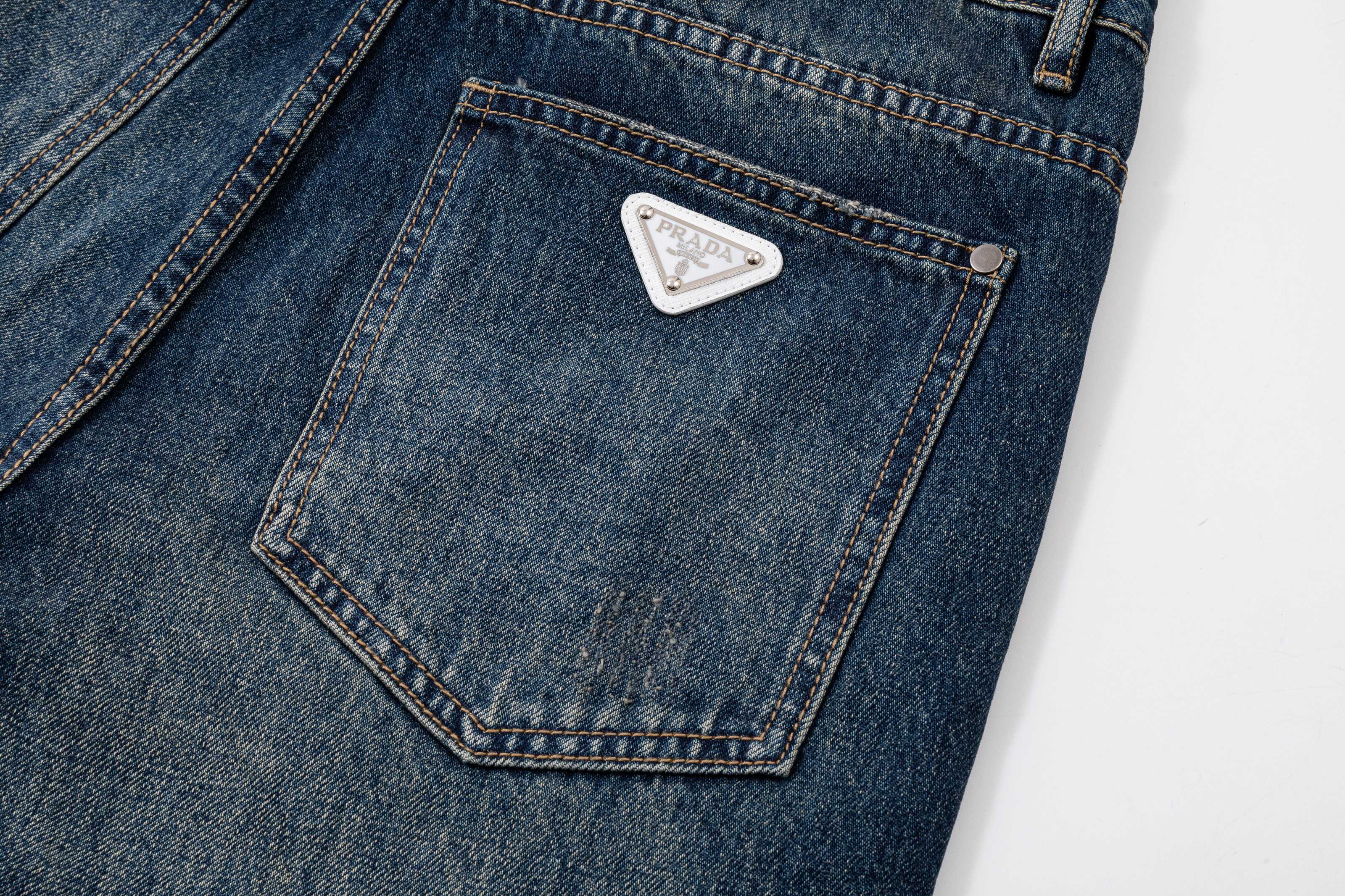 Prada denim pants rear pocket close-up with white triangle logo patch