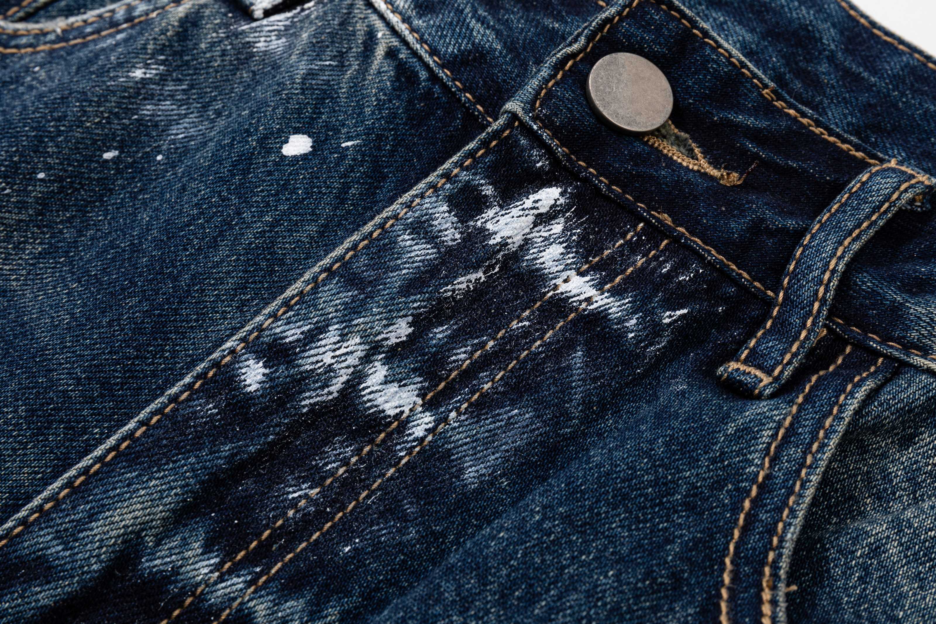 Prada denim pants close-up of belt loop and coin button, dark blue wash