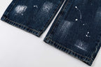 Dark blue denim pants with cuffs and stitched hem, visible distressing marks, flat lay