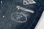 Prada denim pants logo patch with chain graphic, dark blue denim
