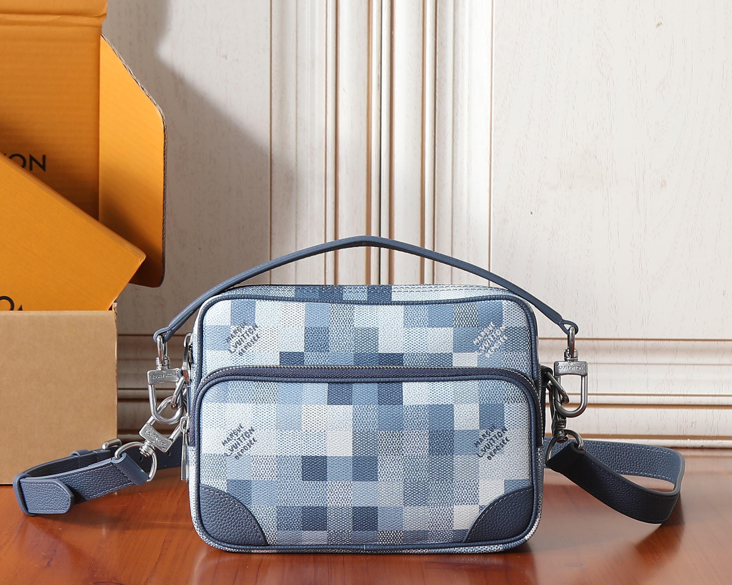 Louis Vuitton crossbody bag in blue check pattern with zip top and short handles