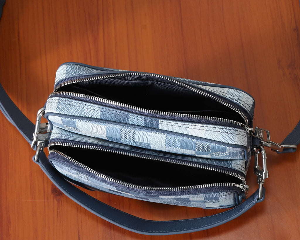 Louis Vuitton crossbody bag showing dual zip compartments and silver-tone zipper pulls
