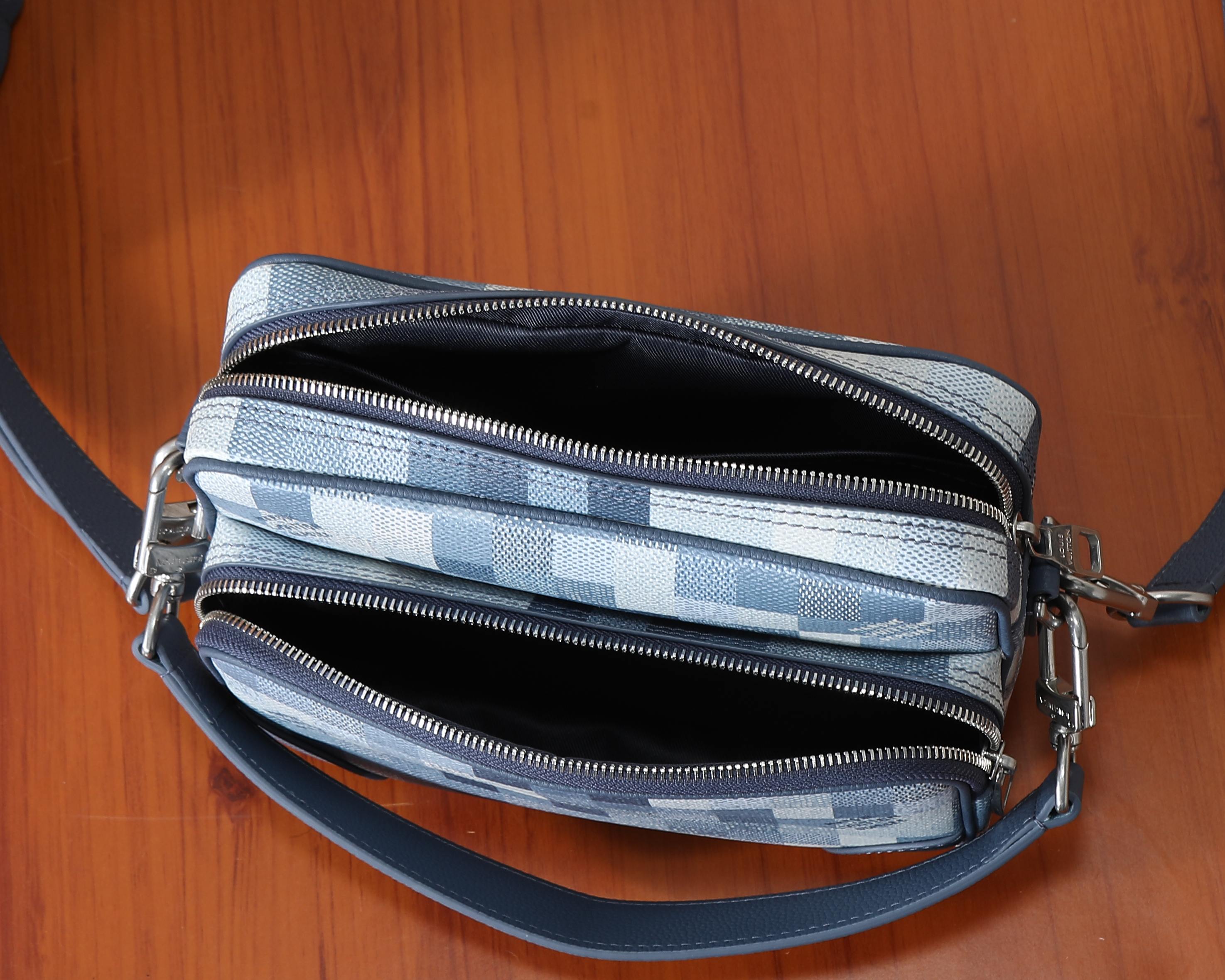 Louis Vuitton crossbody bag showing dual zip compartments and silver-tone zipper pulls
