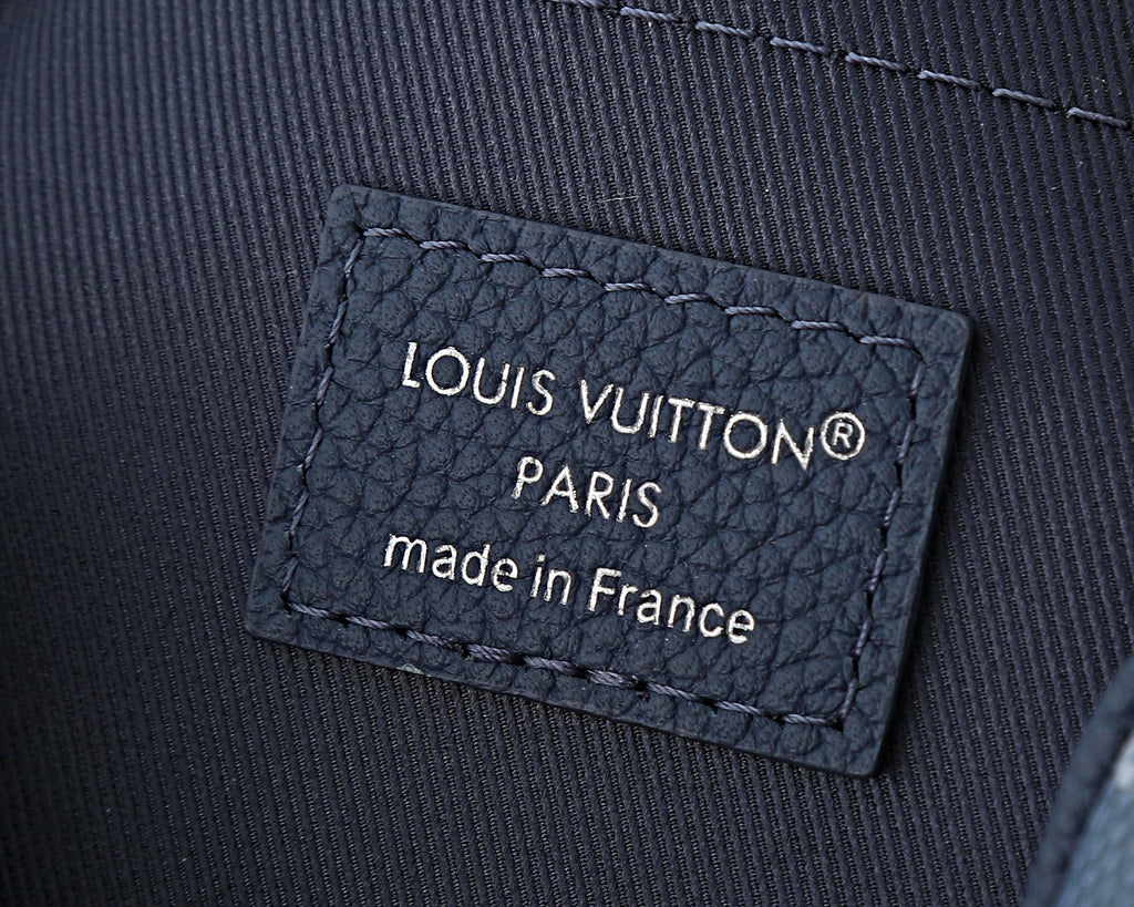 Louis Vuitton leather brand patch reading LOUIS VUITTON PARIS, made in France