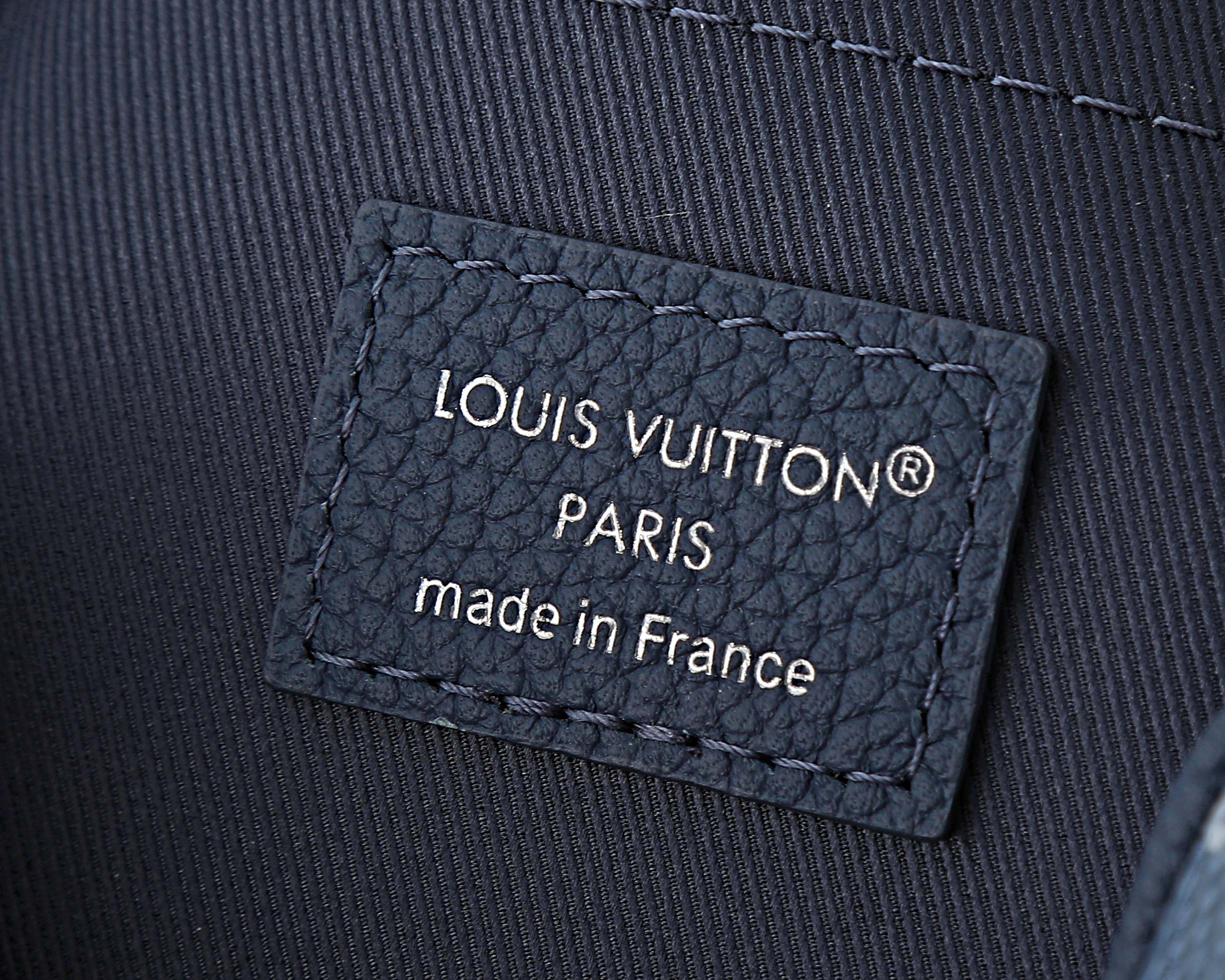 Louis Vuitton leather brand patch reading LOUIS VUITTON PARIS, made in France