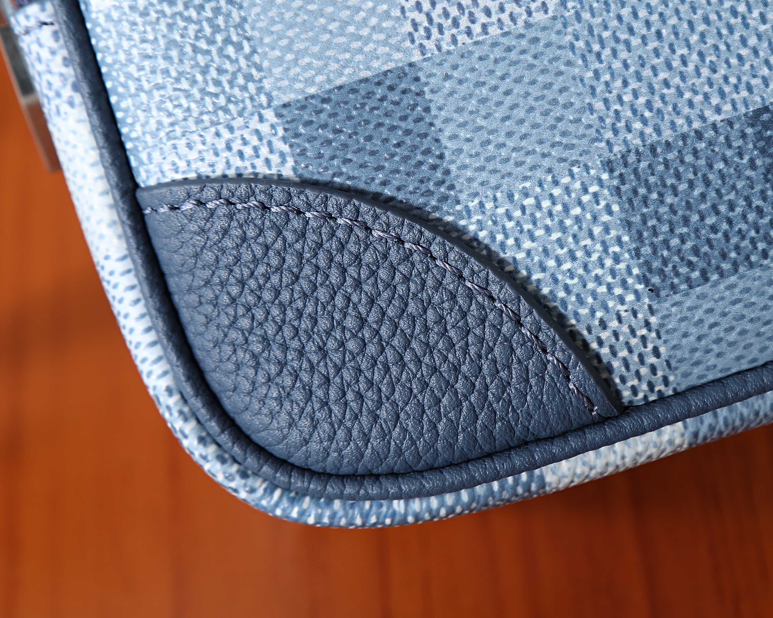 Louis Vuitton bag edge trim with pebbled blue leather and curved stitched seam