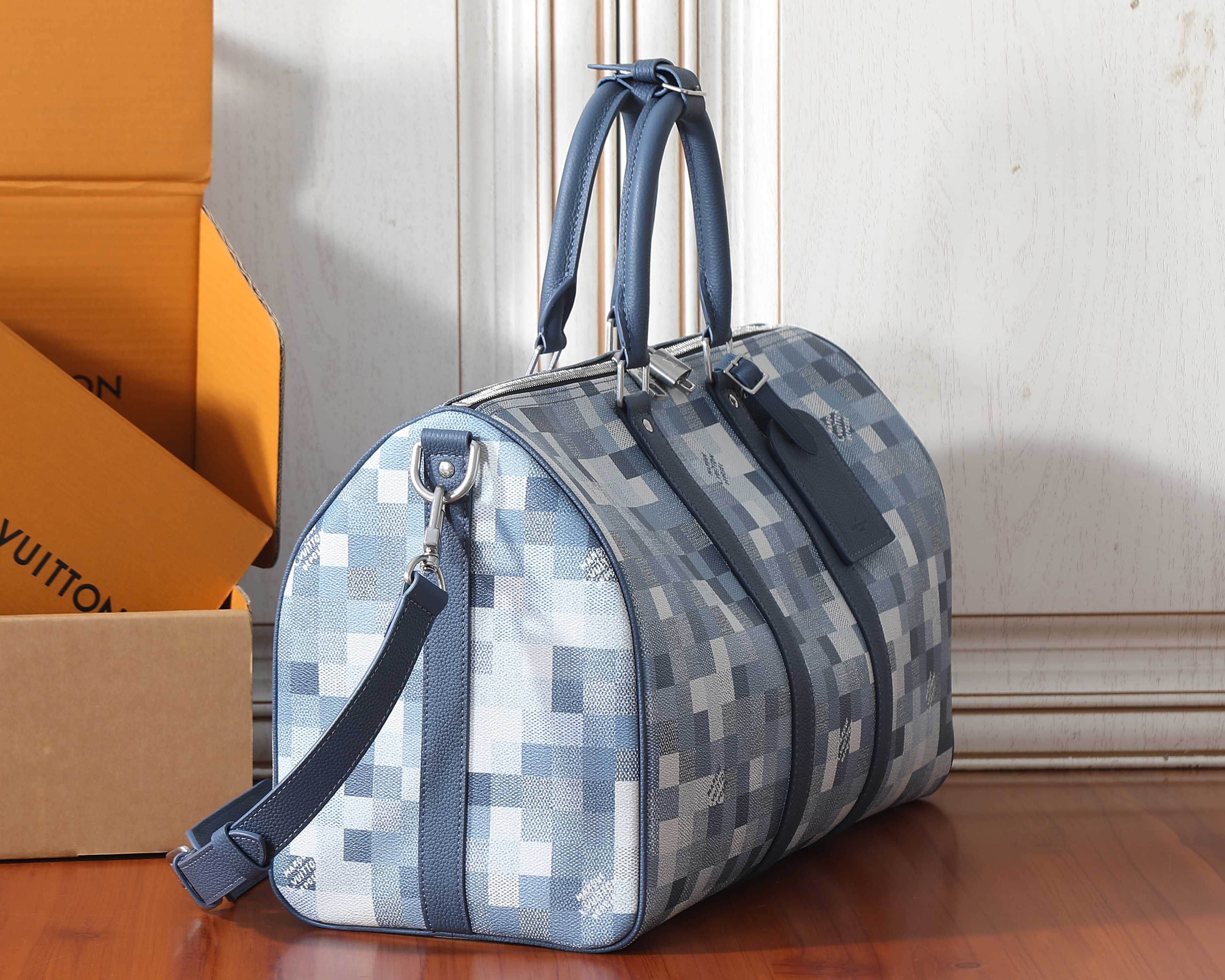 Louis Vuitton checkerboard duffel bag with shoulder strap and side handles