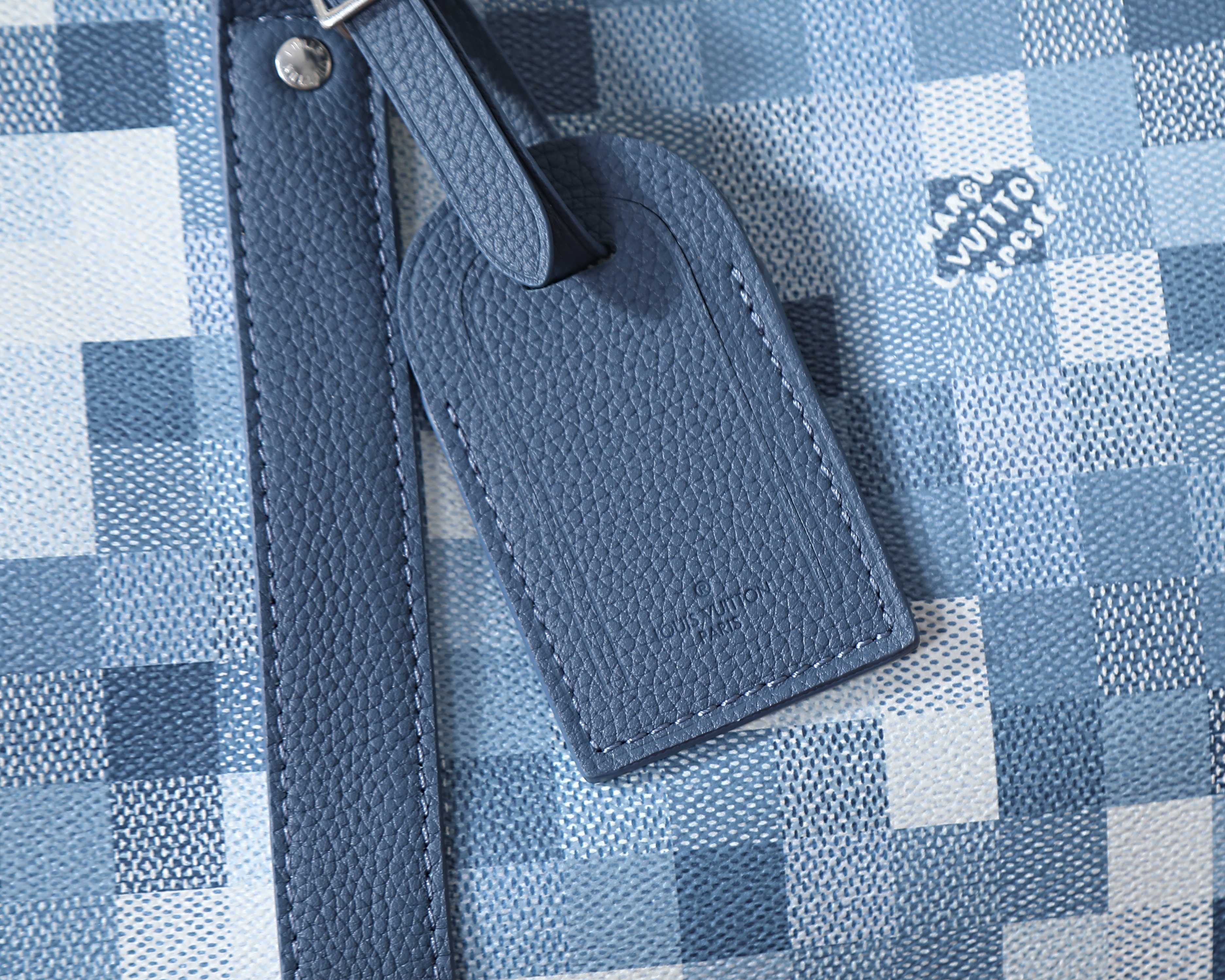 Louis Vuitton duffel bag leather luggage tag on blue checkered canvas