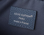 “LOUIS VUITTON” Paris label on blue crossbody bag fabric.
