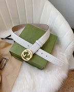 Gucci belt with white strap, embossed logo, and large gold double-G buckle