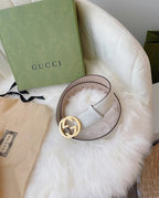 Gucci belt on loop: white embossed strap with gold interlocking G buckle