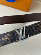 Dark monogram belt with embossed leather back and sparkling silver-tone LV buckle.