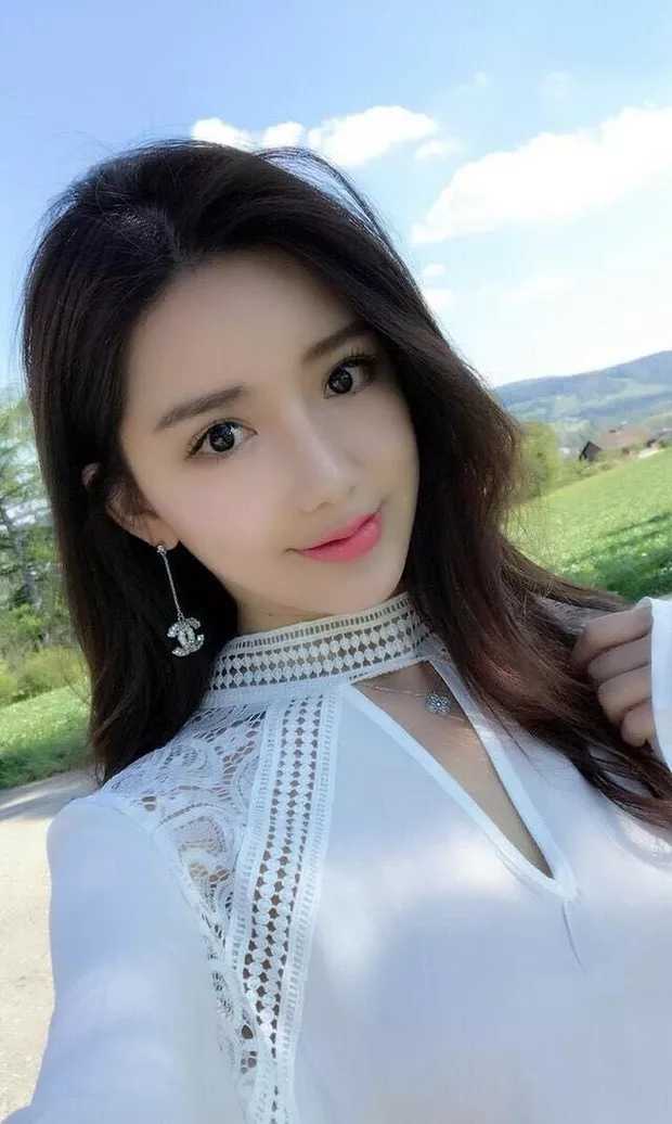 Silver-tone Chanel logo earrings with rhinestone details, worn by model